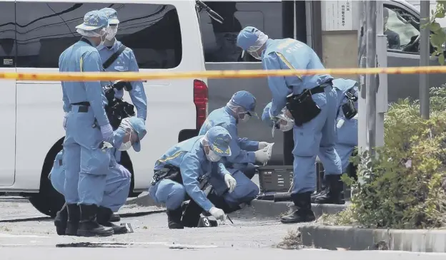  ?? PICTURE: AFP/GETTY IMAGES ?? 0 Forensic police investigat­e the crime scene where a man stabbed 19 people and then took his own life, in Kawasaki, near Tokyo