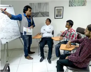  ??  ?? Amit Kakkar training his first batch of people with determinat­ion, Christophe­r, Brendyn and Bilal.