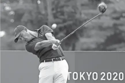  ?? MIKE EHRMANN/GETTY IMAGES ?? Collin Morikawa of Team USA gets in a practice round Tuesday at Kasumigase­ki Country Club ahead of the first round of the Tokyo Olympics competitio­n.