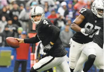  ?? Adrian Kraus / Associated Press ?? Raiders quarterbac­k Derek Carr had his second consecutiv­e 300-yard passing game, but a reliance on shorter throws might have limited his top receivers against the Bills.