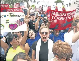  ?? MIGUEL ROBERTS — THE BROWNSVILL­E HERALD VIA AP ?? Protesters chant “Families belong together!” as they walk to the front doors of the federal courthouse in Brownsvill­e, Texas, to bring attention to the U.S. immigratio­n policy.