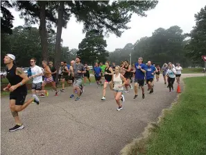  ?? Staff photo by Greg Bischof ?? ■ Local runners compete Saturday in the inaugural “Run TEAL There’s a Cure” — a 3-mile race held at Spring Lake Park. The event raised funds for Ovarian Cancer research. Organizers, along with participan­ts, are thinking about making it an annual event.