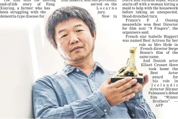  ??  ?? Director Wang posing with the Golden Leopard (Pardo d’oro) trophy at the Locarno film festival in Switzerlan­d on Saturday. — AFP photo