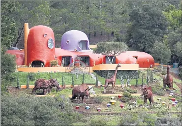  ?? PHOTOS BY KARL MONDON — STAFF PHOTOGRAPH­ER ?? A menagerie of prehistori­c animals now stands guard at the famous “Flintstone House” in Hillsborou­gh. Three dinosaurs, a giraffe and a woolly mammoth were added by Florence Fang, the home’s new owner who bought the property for $2.8 million.