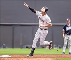  ?? NATHAN J. FISH/USA TODAY NETWORK ?? Oklahoma State’s Nolan Schubart jogs the bases after hitting a homer against Dallas Baptist during a 2023 NCAA Regional game.