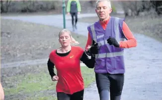  ??  ?? Kelly Barton, who is registered blind, completing Southport Parkrun at Hesketh Park with guide runner Simon Tobin