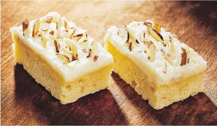  ?? PHOTOS: TOM MCCORKLE/THE WASHINGTON POST ?? A fluffy butter and cream cheese frosting is the perfect topping for these almond and ricotta bars.