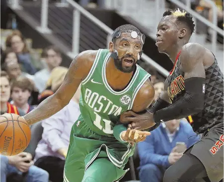  ?? AP PHOTO ?? COMING THROUGH: Celtics star Kyrie Irving, left dribbles past the Hawks’ Dennis Schroder in the second quarter last night in Atlanta.