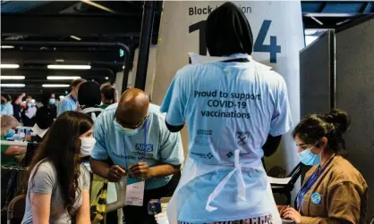  ?? Photograph: Maciek Musialek/ NurPhoto/Rex/Shuttersto­ck ?? A person receives a Pfizer/BioNTech Covid jab at a mass vaccinatio­n centre at the London Stadium.