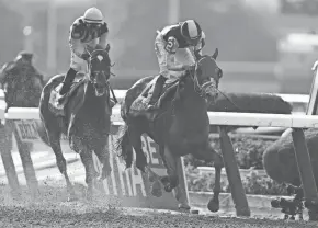  ?? GETTY IMAGES ?? Tapwrit, with jockey Jose Ortiz, runs 11⁄2 miles in 2:30.02 to win on his home track of Belmont Park. Tapwrit overtook favored Irish War Cry in the stretch to win by two lengths.