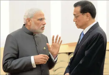  ?? PHOTO: AP ?? Indian Prime Minister Narendra Modi (left) talks with Chinese Premier Li Keqiang at the Great Hall of the People in Beijing, China. The author says Modi’s strategy to navigate the impossible trinity of the US, China and Europe-Russia has three core...