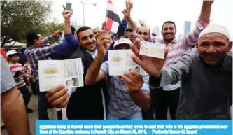  ??  ?? Egyptians living in Kuwait show their passports as they arrive to cast their vote in the Egyptian presidenti­al elections at the Egyptian embassy in Kuwait City, on March 16, 2018. —Photos by Yasser Al-Zayyat