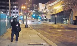  ?? Lawrence K. Ho Los Angeles Times ?? DOWNTOWN AT night is still a work in progress. The disheveled and dispossess­ed reclaim their space when the commuters have cleared out.