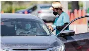  ?? AL DIAZ adiaz@miamiheral­d.com ?? A driver prepares to be vaccinated at Tropical Park in West Miami-Dade on Oct. 6.