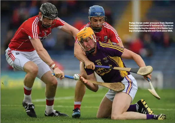  ??  ?? Podge Doran under pressure from Damien Cahalane and Conor O’Sullivan in Thurles on Saturday during the county’s first Senior hurling championsh­ip win over Cork since 1956.