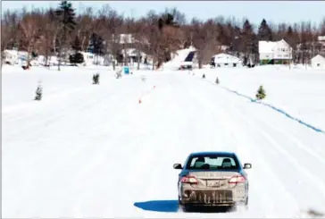  ?? AFP ?? A car drives across the ice road connecting the towns of Pointe-Fortune and Saint-Andre-d’Argenteuil in Pointe-Fortune, Quebec, on February 17.