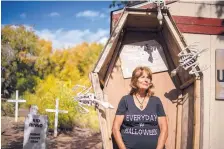  ?? ROBERTO E. ROSALES/JOURNAL ?? Sharon Chism, seen here trying on a coffin for size, started the Jemez Haunted Graveyard in Cañon in 2015. She said she enjoys preserving the fun of Halloween and meeting the people who stop to visit the eerie and elaborate attraction in her front yard.