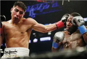  ?? FRANK FRANKLIN II — THE ASSOCIATED PRESS ?? Jessie Vargas, left, hits Adrien Broner with a left during the fourth round of a welterweig­ht boxing match Saturday in New York.