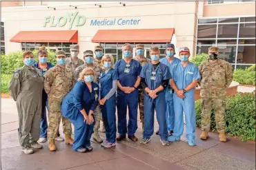  ?? Ryan smith, FMC, File ?? In this May 2020 file photo, hospital workers thanked National Guardsmen who came to Floyd Medical Center to assist the hospital during the pandemic. Gov. Brian Kemp announced this week that 200 Georgia National Guard troops will be deployed beginning Jan. 3 in response to surges in COVID-19 numbers.