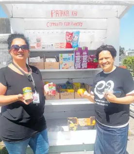  ??  ?? Te Ha Oranga staff, Cara Donaldson and Virginia Wati show just some of the free items within the newly establishe­d community food pantry.
