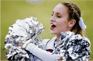  ??  ?? Fifteen-year-old Palm Beach Central student Ashley Jacob performs a cheer with pompoms during the game between Palm Beach Central and Atlantic at Atlantic High School in Delray Beach on Saturday.