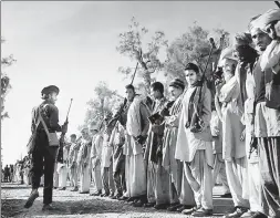  ?? MARGARET BOURKE-WHITE/GETTY ?? Pathan tribesmen waiting to march into Kashmir, December 1947