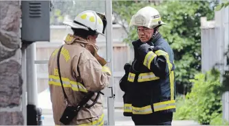  ?? DAVE JOHNSON THE WELLAND TRIBUNE ?? In this file photo, Port Colborne Fire and Emergency Services Deputy Fire Chief Mike Bendia, left, and Fire Chief Tom Cartwright, right, stand outside an apartment building at 45 Victoria St. on Sunday July 2, 2017 in Port Colborne. Firefighte­rs dealt...