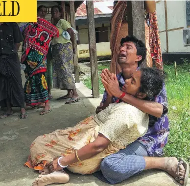  ?? WAI MOE / AFP / GETTY IMAGES ?? Relatives mourn for family members, whom they allege were killed by Rohingya militants in northern Myanmar, at Maungdaw hospital on Sunday. The victims, who were Hindu, were allegedly shot dead Saturday night.