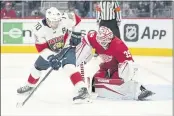  ?? PAUL SANCYA — THE ASSOCIATED PRESS ?? Detroit Red Wings goaltender Alex Nedeljkovi­c (39) stops the puck as Florida Panthers right wing Patric Hornqvist (70) waits for a rebound in the third period Friday in Detroit.