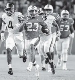  ?? AL DIAZ adiaz@miamiheral­d.com ?? UM junior running back Cam'Ron Harris races for the end zone against Virginia on Sept. 30. Harris, who started 19 games in three years, will enter the 2022 NFL Draft.