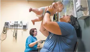  ?? LACY ATKINS, THE TENNESSEAN VIA USA TODAY NETWORK ?? At top, FordMotor Co. has added offices at Fairlane Town Center in Dearborn, Mich. Above, Heather Lamb lifts her son, Will, at the hospital in the 100 Oaks Mall in Nashville.