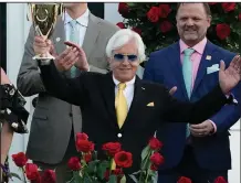  ?? (AP/Jeff Roberson) ?? Trainer Bob Baffert, shown holding the championsh­ip trophy after his horse Medina Spirit won the Kentucky Derby on May 1, was suspended by Churchill Downs on Sunday after the horse failed a post-race drug test. Baffert has denied all wrongdoing.