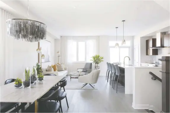  ?? PHOTOS: GORDON KING PHOTOGRaPH­Y ?? The bright and airy open-concept layout of Minto’s Monterey End townhome makes for easy entertaini­ng.