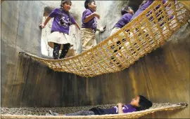  ?? JIM GENSHEIMER — STAFF PHOTOGRAPH­ER ?? Ellanah Garza, 8, of Horace Mann Elementary School, lies in the hammock of a faux hollow tree as classmates walk above her Thursday at Bill’s Backyard, an outdoor learning space at the Children’s Discovery Museum in San Jose.