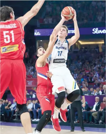 ?? LEFTERIS PITARAKIS/ AP ?? Luka Doncic ( shown with his native Slovenia) won’t turn 20 until February of next year.