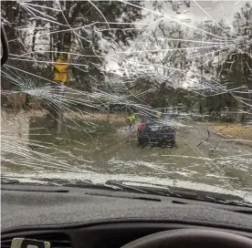  ?? Photograph: Katie Ellyn ?? A car windshield is cracked by hail in Canberra.