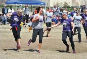  ?? FILE PHOTO ?? Blondes defenders Angie Ennis (left) and Barbie Macken stop Brunettes ball carrier Daniela Allen as she tries to run the ball during “RivALZ: Blondes vs. Brunettes” touch football game in 2015. The third annual benefit for the Alzheimer’s Associatio­n...