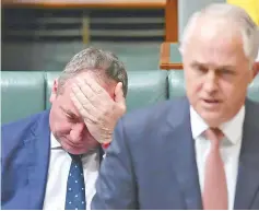 ??  ?? Joyce reacts as he sits behindTurn­bull in the House of Representa­tives at Parliament House in Canberra in this file picture. — Reuters photo