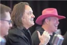  ?? STEPHEN BRASHEAR, AP IMAGES FOR T-MOBILE ?? T-Mobile President and CEO John Legere, center, Chief Operating Officer Mike Sievert, left, and CFO Braxton Carter.