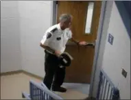  ?? STEVEN SENNE — THE ASSOCIATED PRESS ?? Barrington, R.I., Police Chief John LaCross steps through a stairwell at the police station, in Barrington.