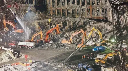  ??  ?? Grim search: Workers and heavy machinery continuing the clean-up and recovery effort in front of the remaining facade of the World Trade Center at ground zero in New York in this file photo taken in 2001. — AP