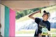  ?? NWA Democrat-Gazette/J.T. WAMPLER ?? Nathan Bunch Vista. paints a tunnel Wednesday on a trail near Bella