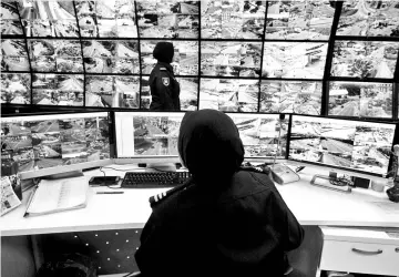  ??  ?? CCTV control room operator showing off the monitoring situation from the control room using the new CCTV facial recognitio­n system during the launching yesterday. - Bernama photo