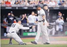  ?? TIM IRELAND/ASSOCIATED PRESS ?? New York’s Aaron Judge, left, and Aaron Hicks celebrate a run, one of nine the Yankees scored in the seventh inning of a 12-8 victory Sunday and a two-game sweep over the Boston Red Sox in London.