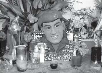  ?? ASSOCIATED PRESS ?? A bust of the late Venezuelan President Hugo Chavez is adorned with flowers, candles and religious images inside a people’s shrine named “Saint Hugo Chavez del 23,” in Caracas, Venezuela.