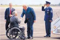  ?? EVAN VUCCI/ASSOCIATED PRESS ?? Texas Gov. Greg Abbott greets President Donald Trump after his arrival at Ellington Field Joint Reserve Base in Houston on Thursday. Trump met with families of the last month’s school shooting and attended two fundraiser­s.