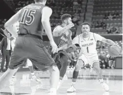  ??  ?? Maryland guard Anthony Cowan Jr., right, drives against Loyola Maryland guard Chuck Champion. Cowan scored a game-high 23 points.