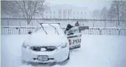  ?? ASSOCIATED PRESS ?? A Secret Service officer opens a patrol car door that was frozen shut in front of the White House on Jan. 23, 2016.