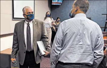  ?? SAMUEL METZ/AP ?? Nevada Gov. Steve Sisolak exits a news conference Wednesday after announcing Nevada would join California, Washington and North Carolina in requiring masks in public.