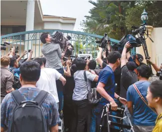  ?? EPA-Yonhap ?? Members of the media gather in front of the North Korea Embassy in Kuala Lumpur, Friday. Kim Jong-nam, half-brother of North Korean leader Kim Jong-un, was killed with a highly toxic chemical weapon known as VX nerve agent, Malaysian police said in a...